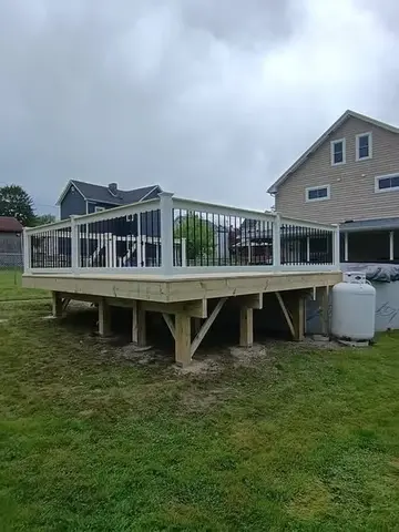 New wooden deck with white railings by KMA Carpentry