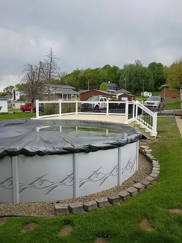 Deck with above-ground pool by KMA Carpentry
