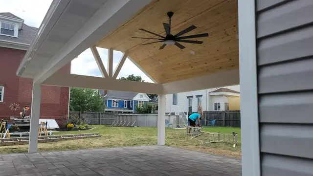 Covered porch ceiling with wood finish by KMA Carpentry