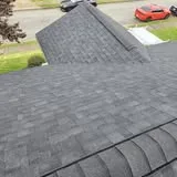 Residential roof with dark asphalt shingles by KMA Carpentry